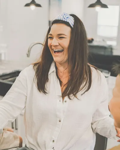 Smiling baker holding a muffin tray